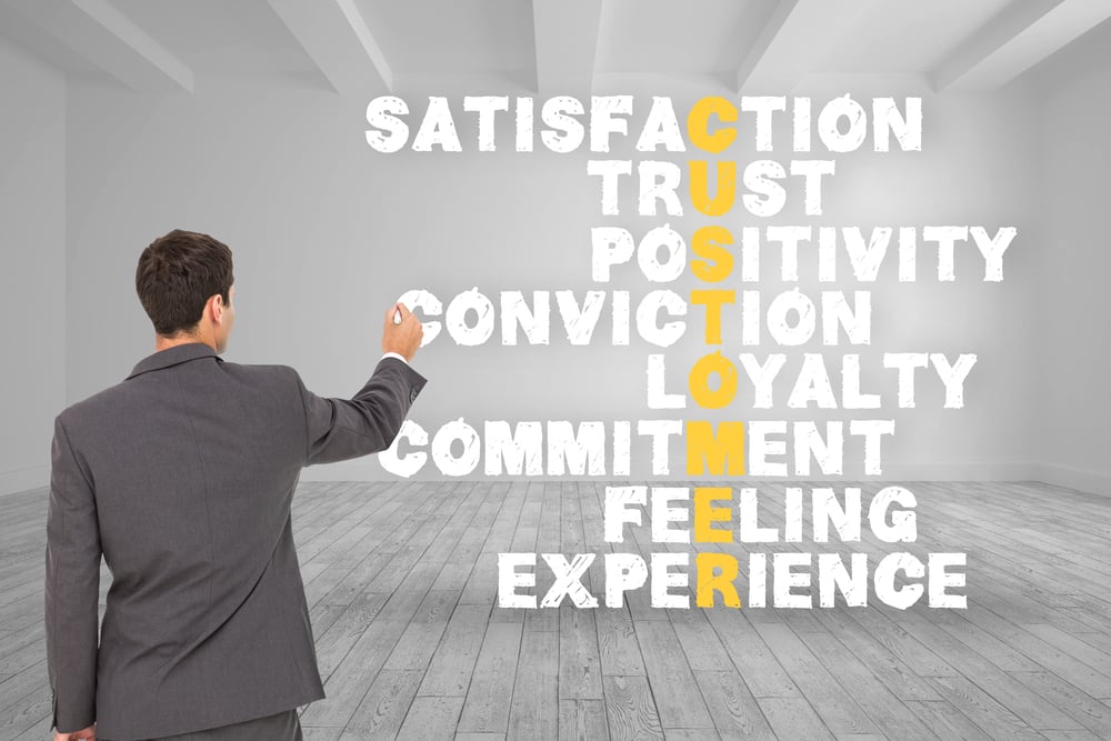 Composite image of businessman standing back to camera writing with marker